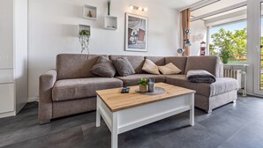 Un salon moderne avec un canapé, une table basse et un tableau encadré au mur.
