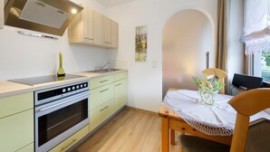A kitchen with a stove, oven, and cabinets. - Apartment 'Thum' with Private Terrace and Wi-Fi (Daisendorf)