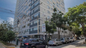 A multi-story hotel with a modern design, featuring a mix of glass and concrete facades.