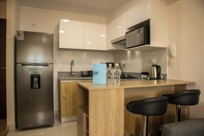 Fridge, microwave, stovetop, coffee/tea maker