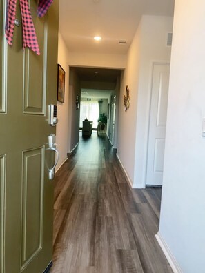 Stylish hallway leads to a dining area with a table and chairs.