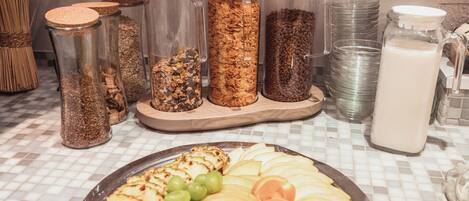 A breakfast buffet with various food items and containers.