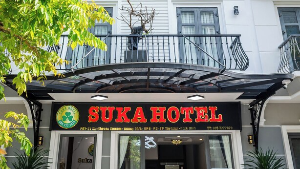The exterior of Suka Hotel, featuring a modern facade, a covered entrance, and a visible balcony. - Suka Hotel (Tan Ninh)