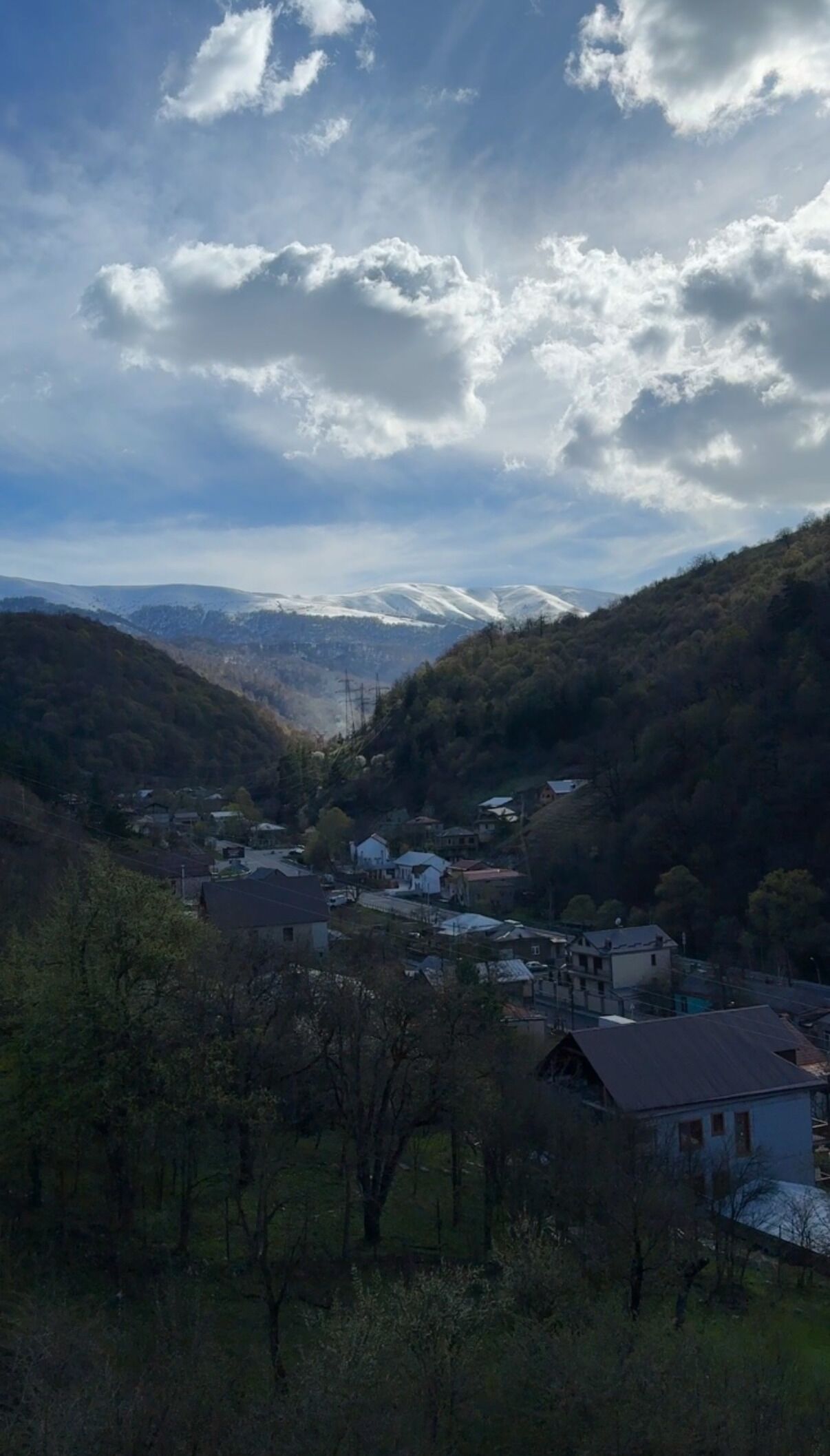 A mountainous landscape with a village nestled in a valley.