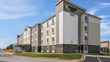 A multi-story hotel with a modern design, featuring a prominent logo and the address 4309.