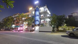 A multi-story building with a modern design, featuring balconies and large windows. - Hotel Spectrum Inn - By ASPL (Noida)