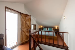 Cozy retreat with a comfortable bed, bedside tables, and a large window.