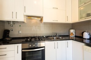 Enjoy cooking in this well-equipped kitchen with an oven, coffee maker, and kettle.