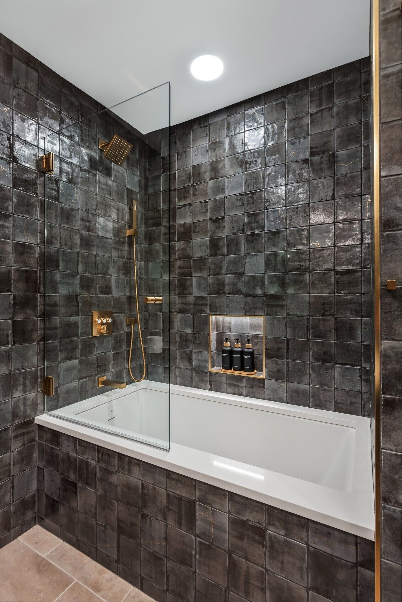 A modern bathroom with a freestanding bathtub, a glass-enclosed shower, and a small shelf with toiletries.