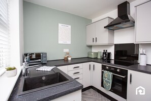 Fridge, oven, coffee/tea maker, cookware/dishes/utensils