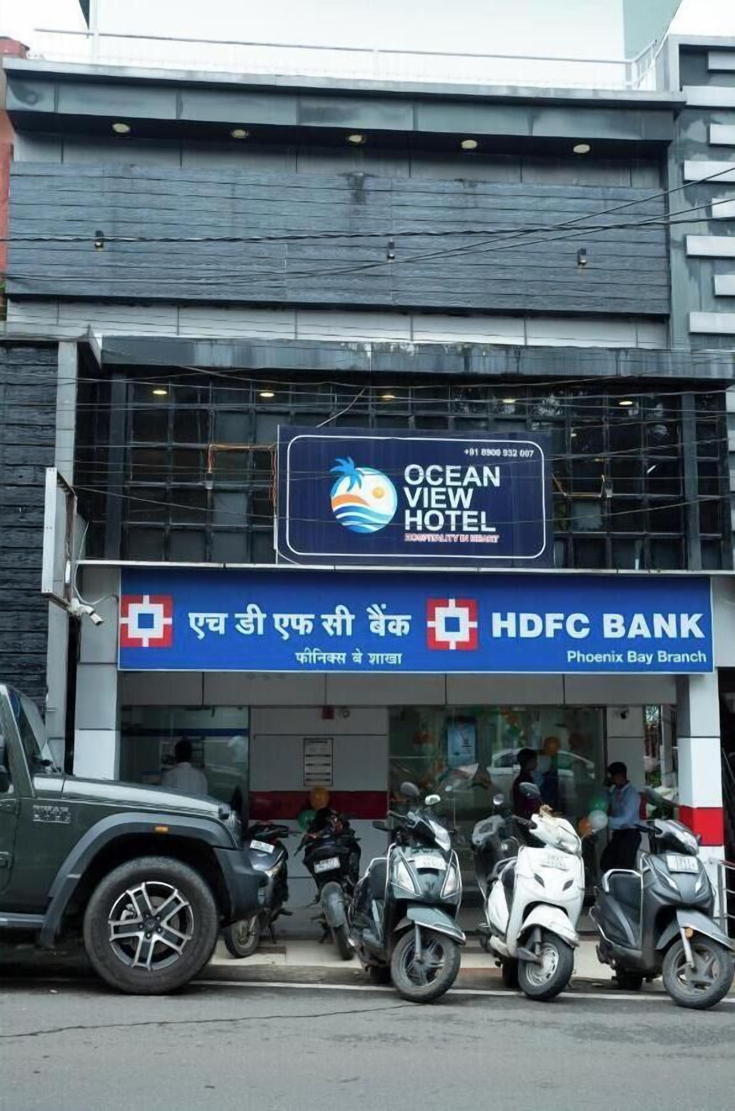 A building with a sign for Ocean View Hotel and HDFC Bank Phoenix Bay Branch.
