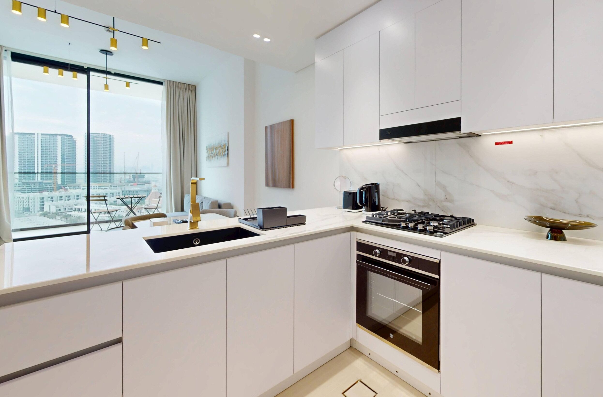 A modern kitchen with a built-in dishwasher, a stove, and a coffee maker.