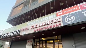 A building with a sign for "Nikanshivee Hotel & Restaurant" and "Kalakrithi Hotel". - Hotel Nikanshvee (Udaipur)