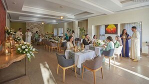 A spacious dining area with multiple tables and chairs, a decorative wall, and a large painting. - 
THE RIAD PEARL OF MARRAKECH (Jdid)