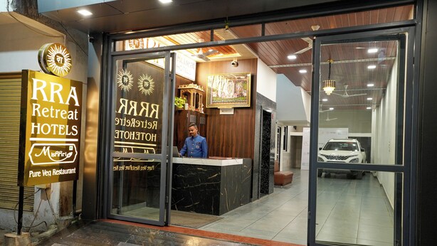 The entrance of RRA Retreat Hotels with a reception desk and a receptionist. - RRA Retreat Hotel (Nathdwara)