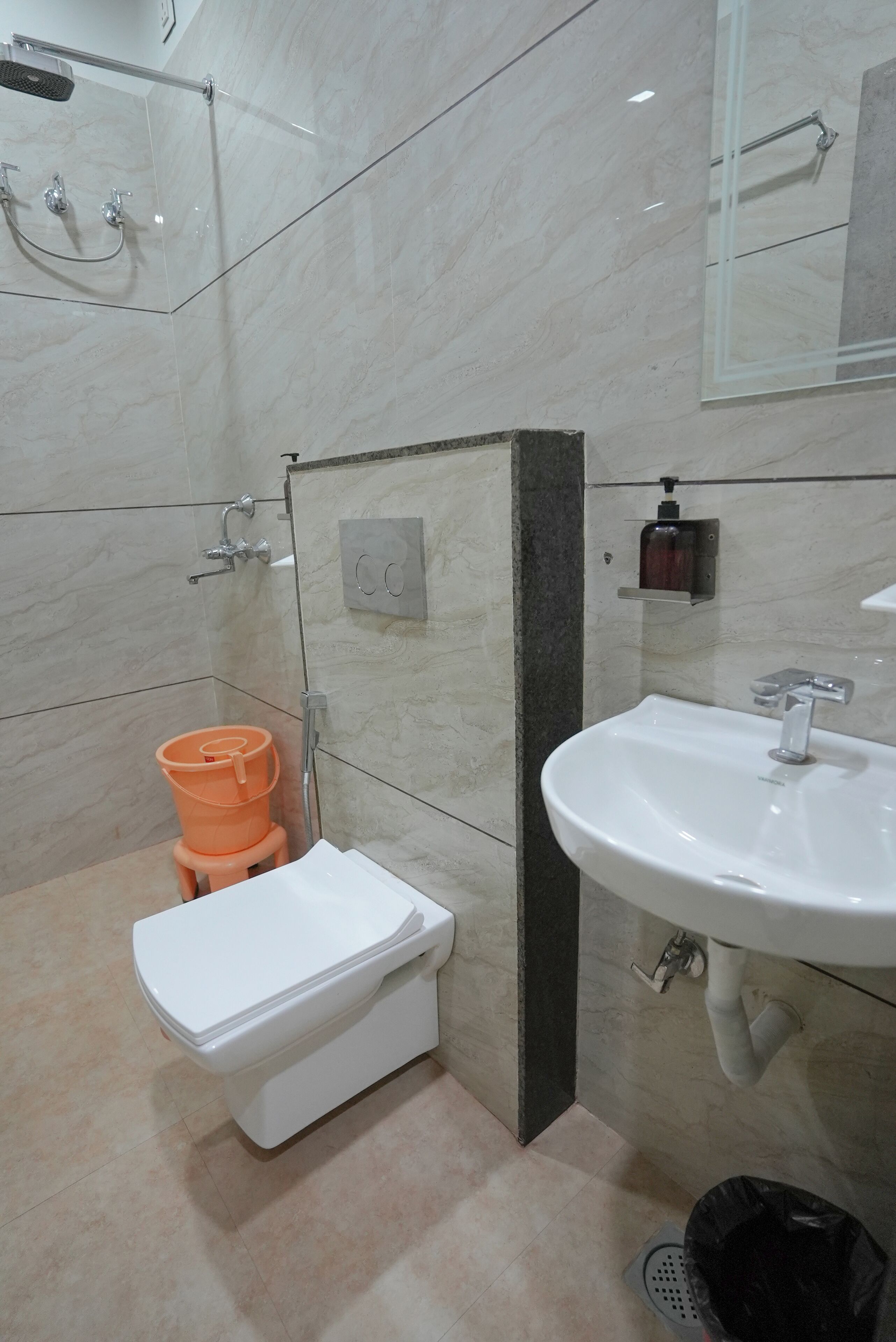 A bathroom with a toilet, sink, and shower.