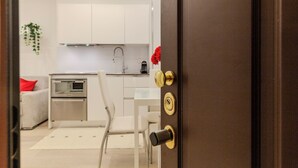 A modern kitchen with white cabinets, a stainless steel oven, and a coffee machine. - notaMi - Campus Bligny Bocconi District (Milan)