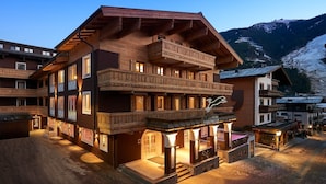 A multi-story hotel with wooden balconies and a sign reading "Hotel Panthera." - Hotel Panther'A (Saalbach)