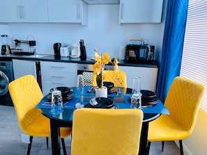 A compact kitchen with white cabinets, a microwave, and a coffee maker. - Cosy City Apartment in Leicester (Leicester)