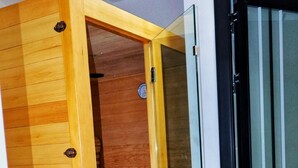 A wooden sliding door with a glass panel, leading to a room with a wooden floor and a small wooden stool. - Comfort home! made life simple, Beautiful views and desirable lifestyle. (Nairobi)