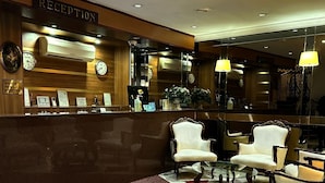 A reception area with a reception desk, chairs, and a patterned carpet. - Hotel Büyük Şehzade (Istanbul)