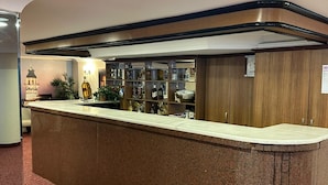 A reception desk with a marble top, wooden paneling, and a glass display case filled with various items. - Hotel Büyük Şehzade (Istanbul)