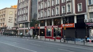 A multi-story hotel with a classic architectural style, featuring large windows and a prominent entrance. - Hotel Büyük Şehzade (Istanbul)