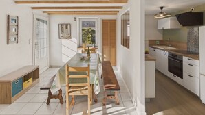 A modern kitchen with white cabinets, a wooden countertop, and a built-in oven. - House in La Torche - Large garden for 4 (Saint-Jean-Trolimon)