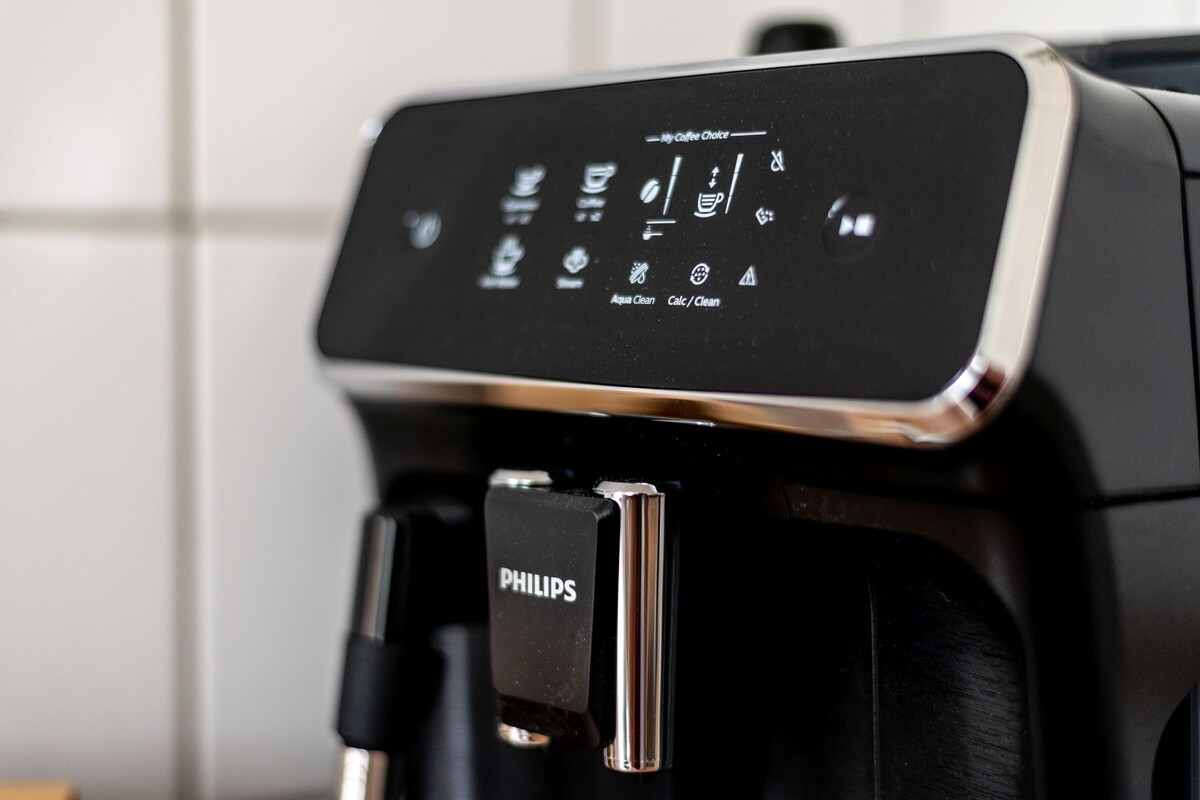 A coffee machine with a digital display and a water reservoir.
