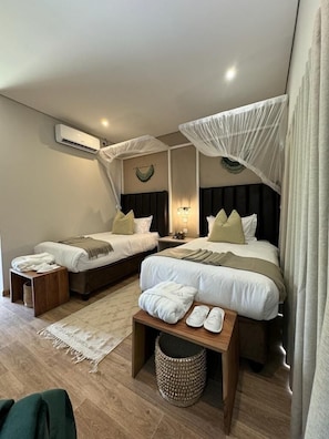 Standard Twin Room, Patio, Pool View | Minibar, in-room safe, desk, laptop workspace - The Telescope Boutique Lodge (Victoria Falls)