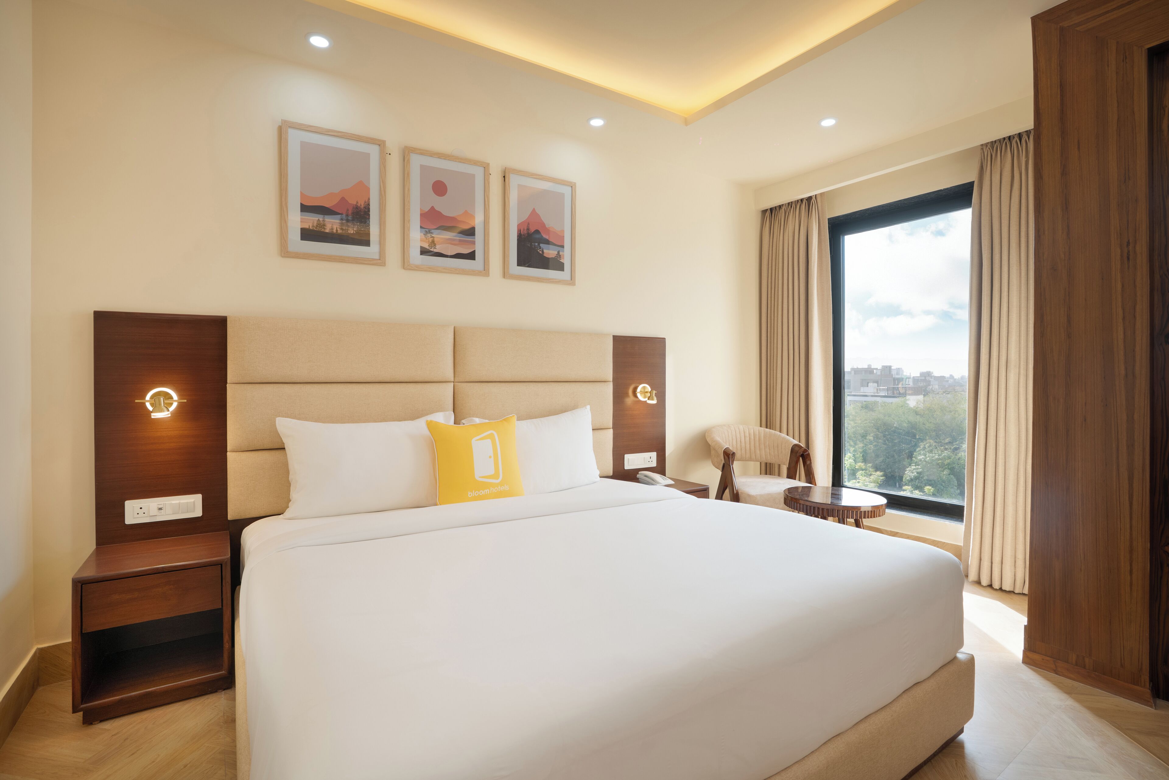 A hotel room with a large bed, two bedside tables, a chair, and a large window with curtains.