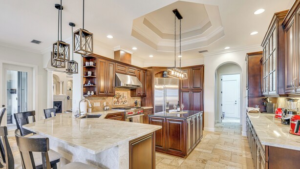 A spacious kitchen with a large island, wooden cabinets, and modern appliances. - 3 Mi to Bonita Beach: Outdoor Oasis w/ Pool & Spa! (Bonita Springs)