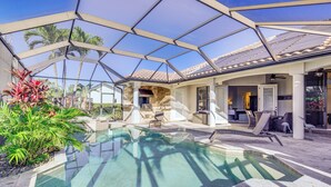A covered outdoor pool area with a glass ceiling, stone flooring, and tropical plants. - 3 Mi to Bonita Beach: Outdoor Oasis w/ Pool & Spa! (Bonita Springs)