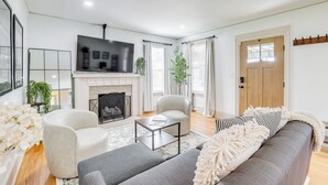 A modern living room with a fireplace, a sofa, a coffee table, and a television. - Walk to Amphitheater & Stadium: Home w/ Deck! (Birmingham)