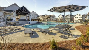 A residential area with a swimming pool, lounge chairs, and a covered patio area. - Poolside Downtime, 4 Mi From Ole Miss (Oxford)