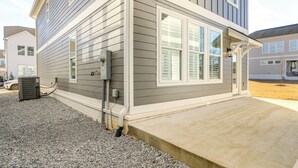 A residential building with a grey siding exterior, a concrete front porch, and a visible air conditioning unit. - Poolside Downtime, 4 Mi From Ole Miss (Oxford)