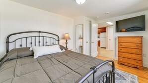 A bedroom with a bed, a dresser, and a television on the wall. - 2 Mi to Suny Cortland: Home Near Hiking & Golf! (Cortland)