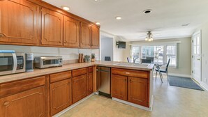 A kitchen with wooden cabinets, a dishwasher, and a microwave. - 2 Mi to Suny Cortland: Home Near Hiking & Golf! (Cortland)