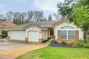 A single-story house with a garage, a front porch, and a landscaped front yard. - Family Home Near Folsom Lake in El Dorado Hills! (El Dorado Hills)