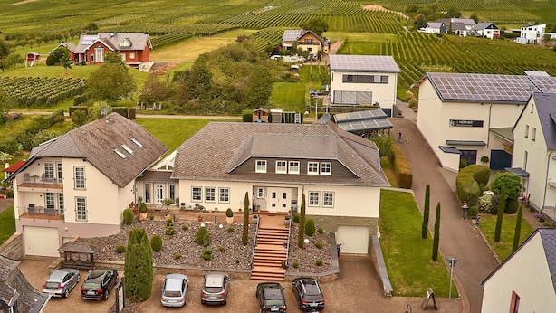 A residential area with houses, a driveway, and a parking area.