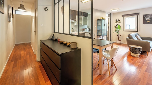 A modern apartment with a kitchen, dining area, and living room.