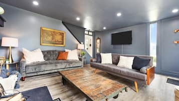 Relax in this stylish living room with two sofas, a coffee table, and a flat-screen TV.