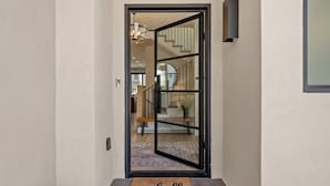 A modern interior with a glass door leading to a staircase. - The Castle 8 Bedroom Home (St. George)