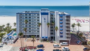 A hotel with a pool, beach view, and parking area. - Beach Villas 706 Top-floor Condo W/ Gulf Views, Pool 2 Bedroom Condo (Fort Myers Beach)