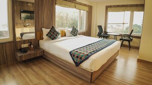 Una habitación de hotel moderna con una cama grande, un escritorio y una silla.