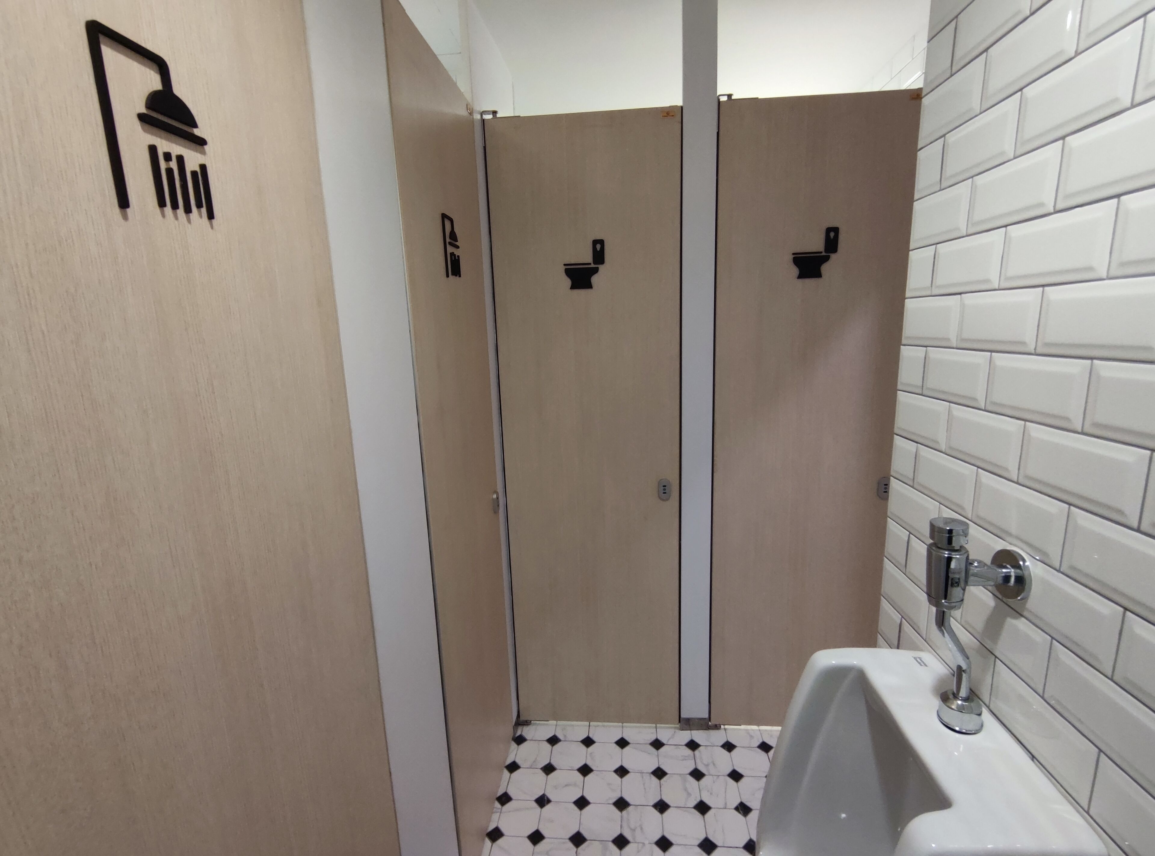 A bathroom with a shower, toilet, and sink.