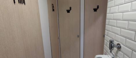 A bathroom with a shower, toilet, and sink.