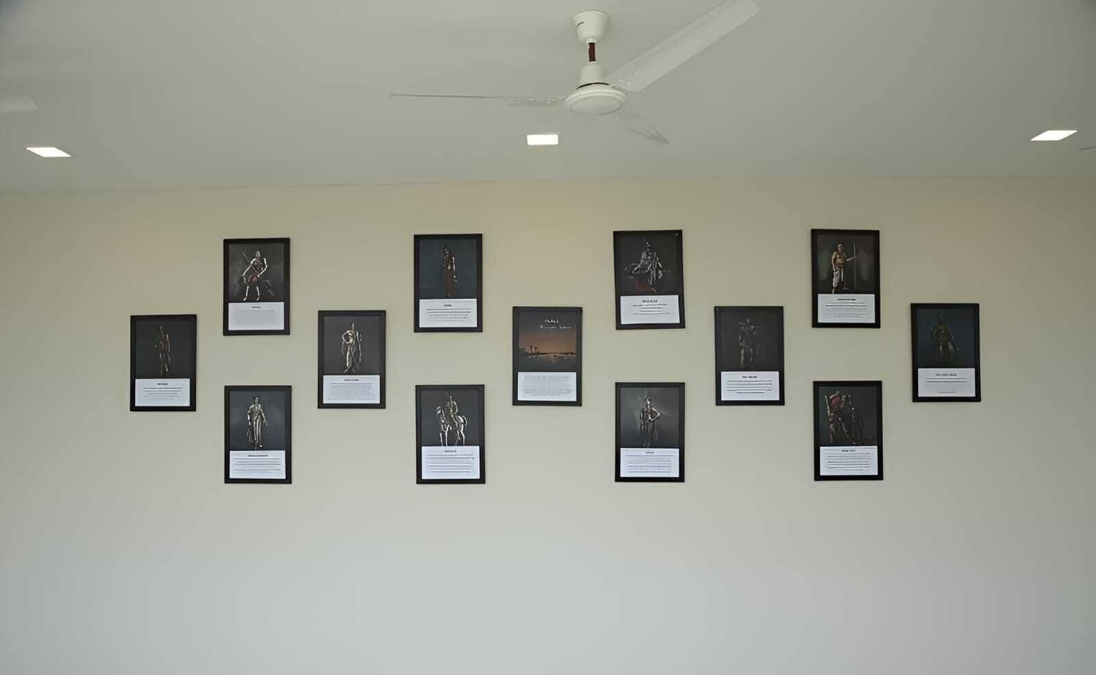A gallery with framed artworks on the wall.