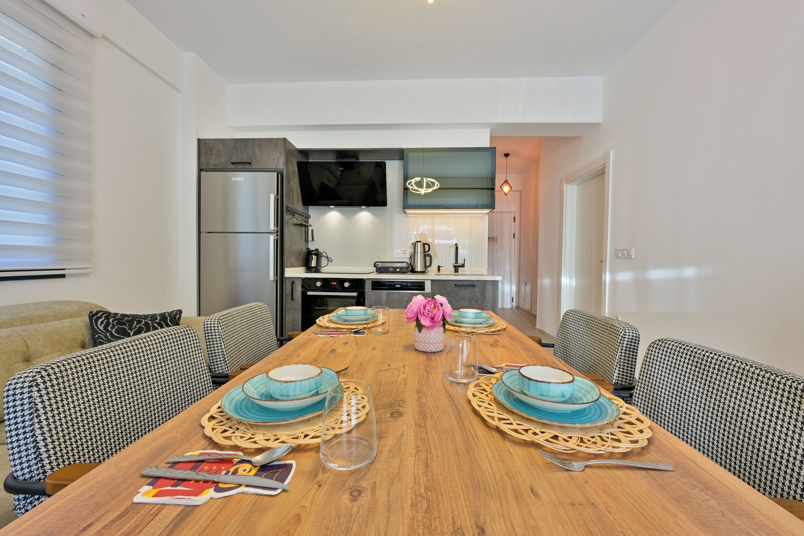 A modern kitchen with a built-in oven, microwave, and a large refrigerator.