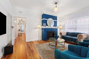 Cozy living area with a fireplace, comfortable seating, and a large window.